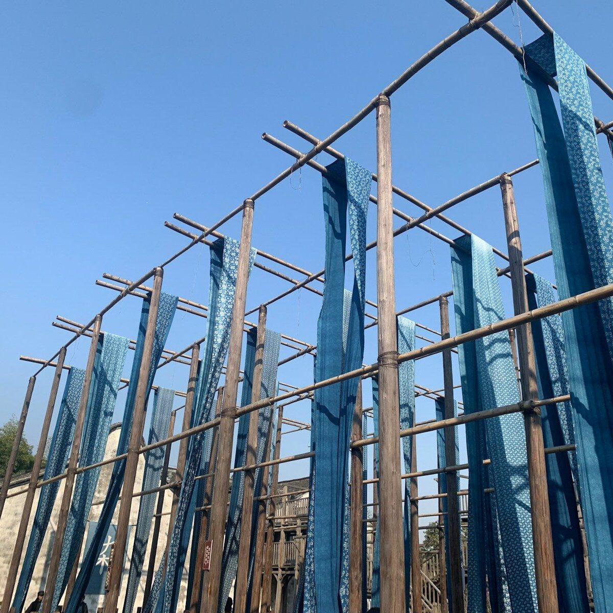 a group of blue metal structures against a blue sky