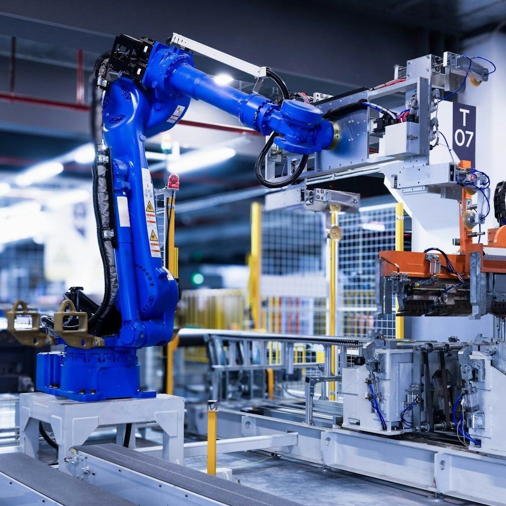 blue industrial robot arm in factory